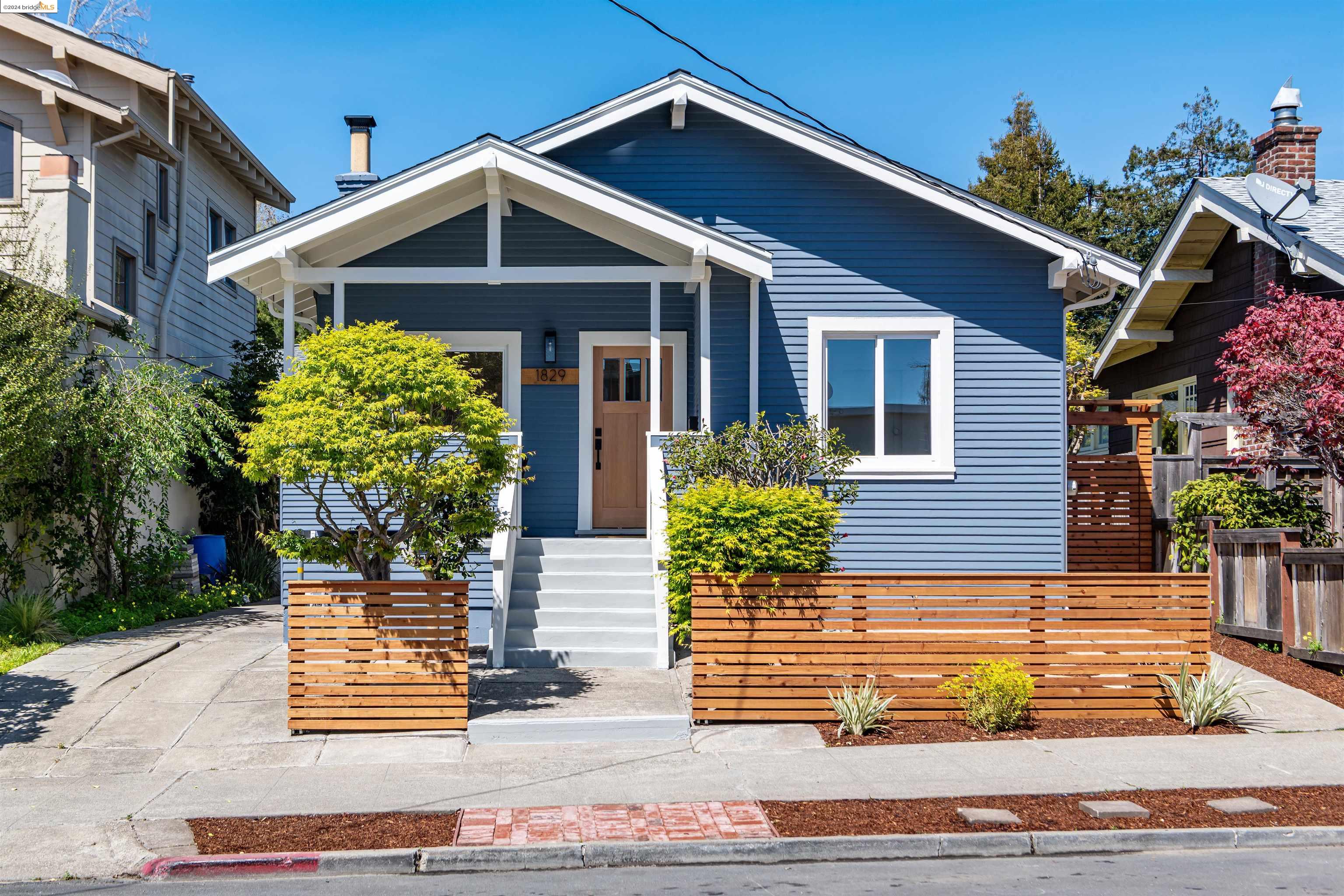 a front view of a house with plants