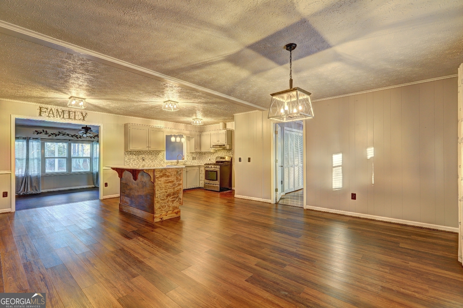 218 City Pond Road Barnesville, GA 30204 - Photo 16 of 51 a view of a room with wooden floor a ceiling fan and windows
