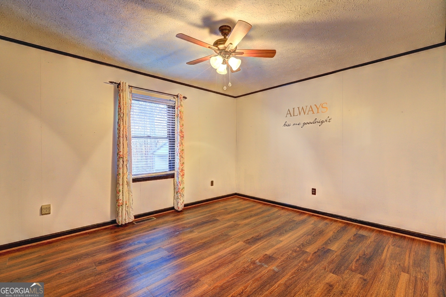 218 City Pond Road Barnesville, GA 30204 - Photo 21 of 51 an empty room with wooden floor and fan