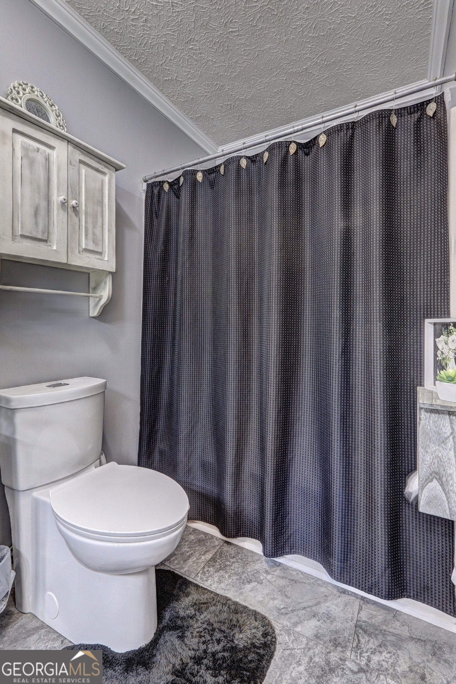 218 City Pond Road Barnesville, GA 30204 - Photo 37 of 51 a white toilet sitting next to a shower curtain