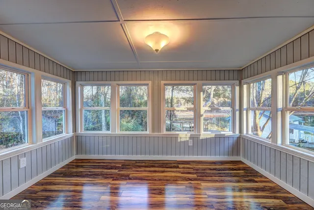 a bedroom with furniture and large windows