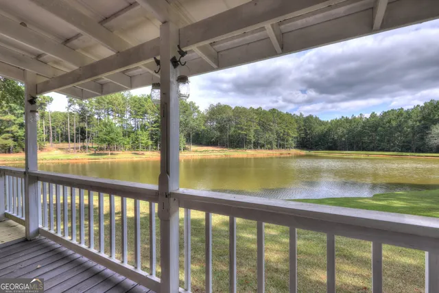 an aerial view of a house with a yard and lake