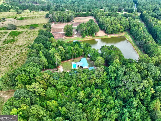 an aerial view of a house with a yard and lake view