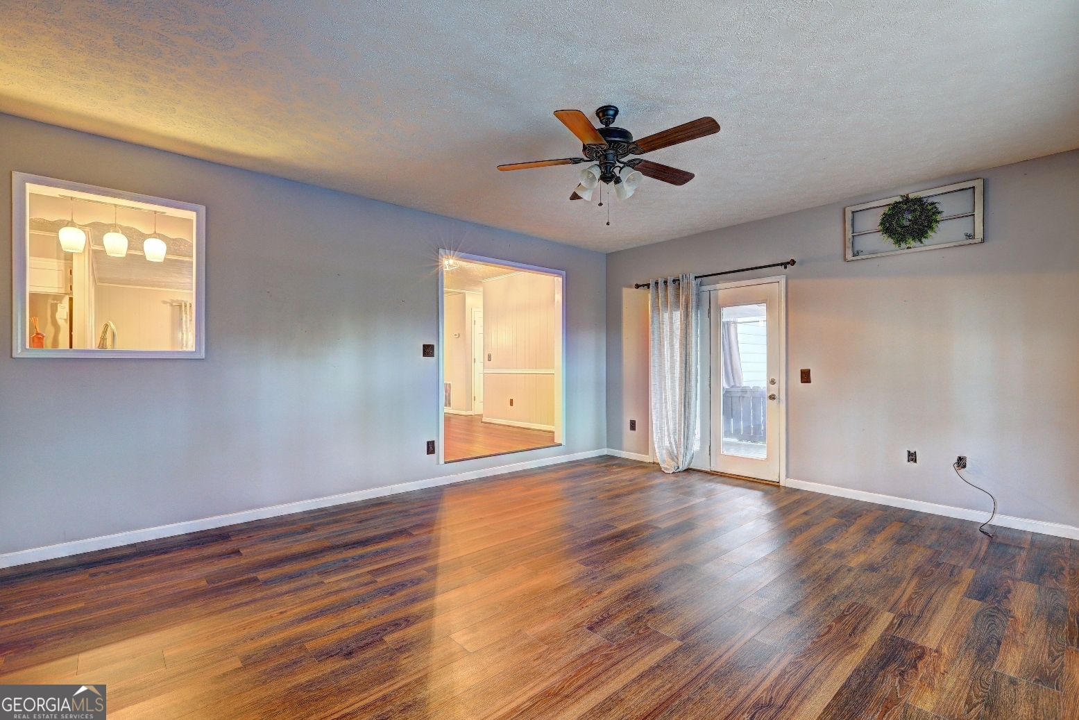 218 City Pond Road Barnesville, GA 30204 - Photo 10 of 51 a view of an empty room with wooden floor and a window