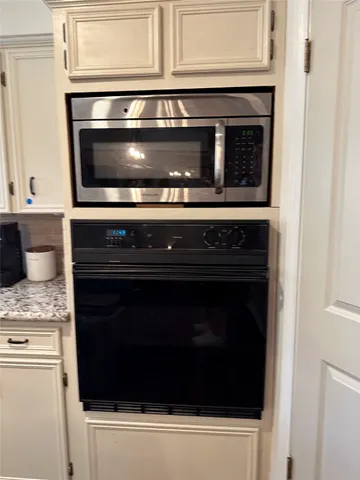 a stove top oven sitting inside of a kitchen