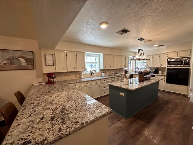 a kitchen with a sink stove and refrigerator