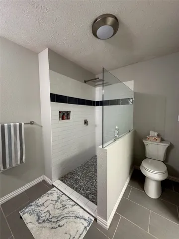 a bathroom with a toilet and a shower