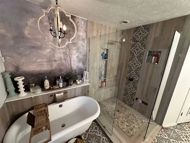 a bathroom with a tub sink and shower
