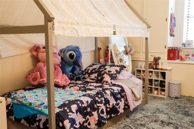 a bed room with a bed and a painting on the wall