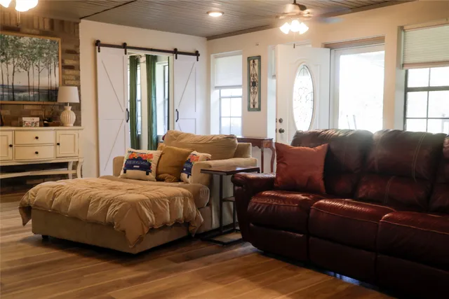 a spacious bedroom with a bed window and couch