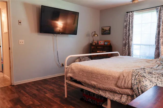 a bedroom with a bed and a flat screen tv