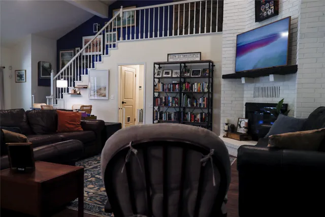 a living room with fireplace furniture and a flat screen tv