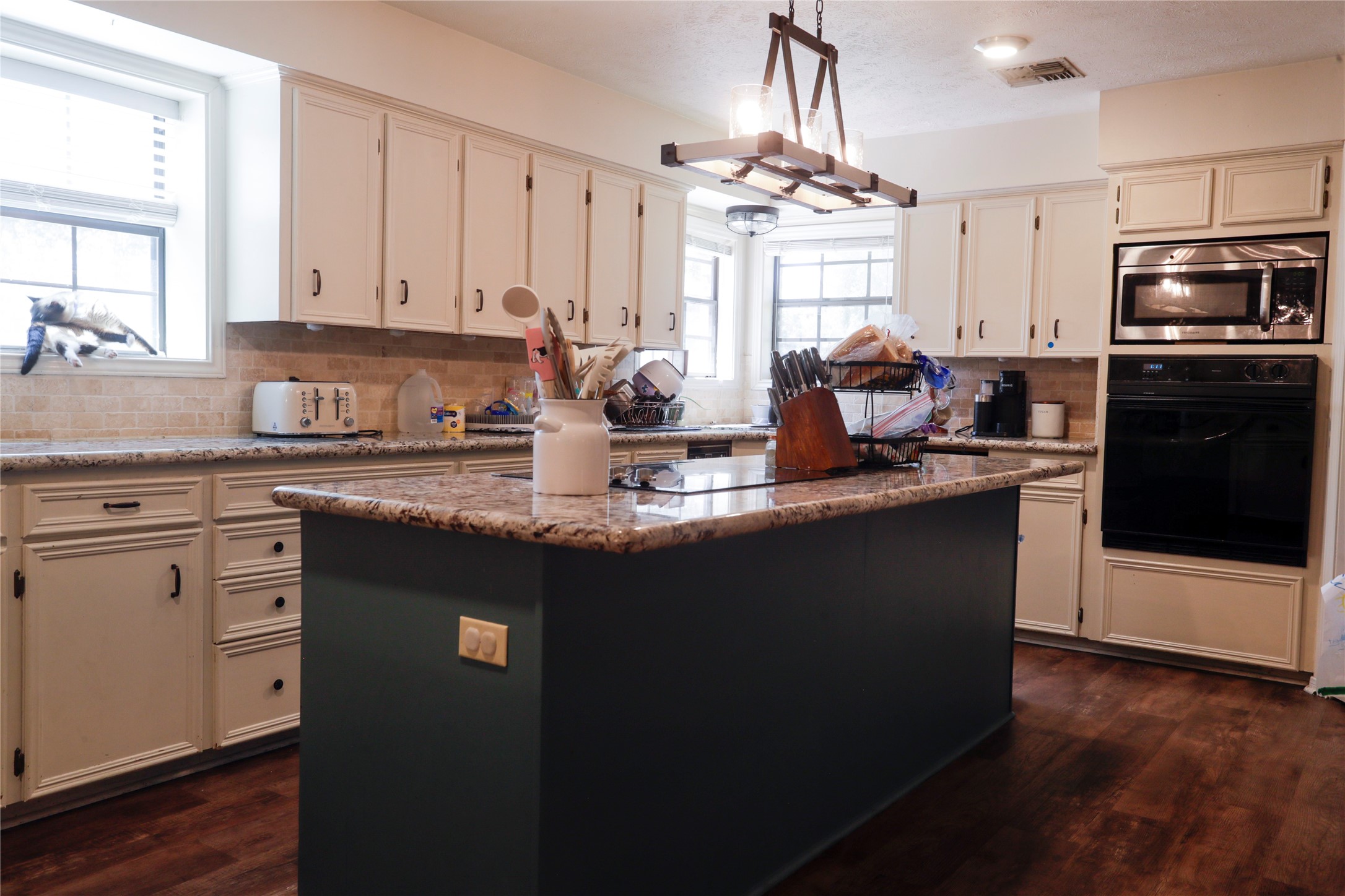 2012 Wilson Road El Campo, TX 77437 - Photo 47 of 50 a kitchen with kitchen island granite countertop a sink cabinets and stainless steel appliances