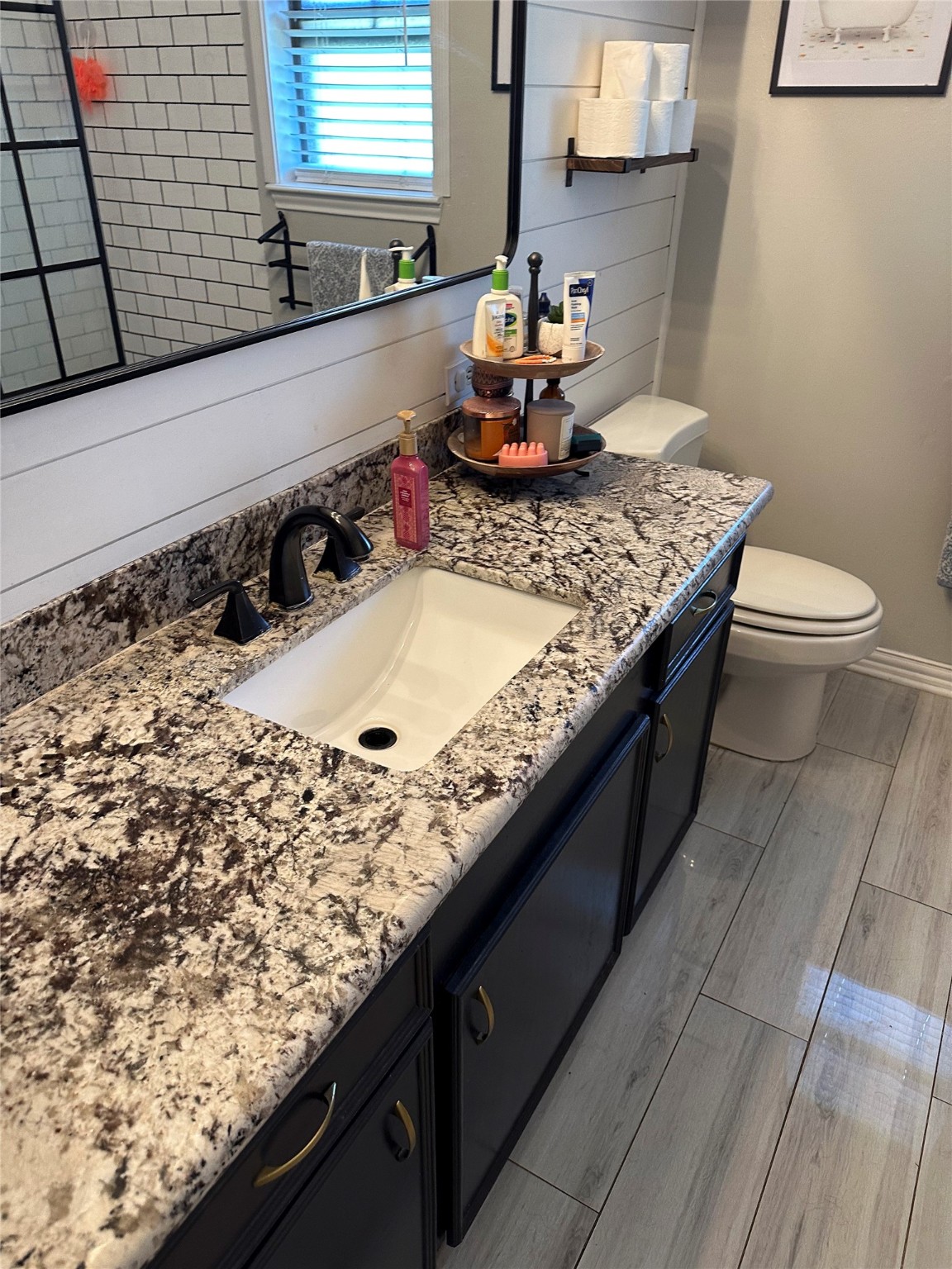 2012 Wilson Road El Campo, TX 77437 - Photo 9 of 50 a bathroom with a granite countertop sink and a toilet