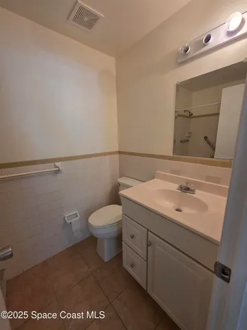 a bathroom with a sink a toilet and mirror
