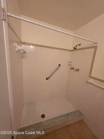 a bathroom with a glass shower door