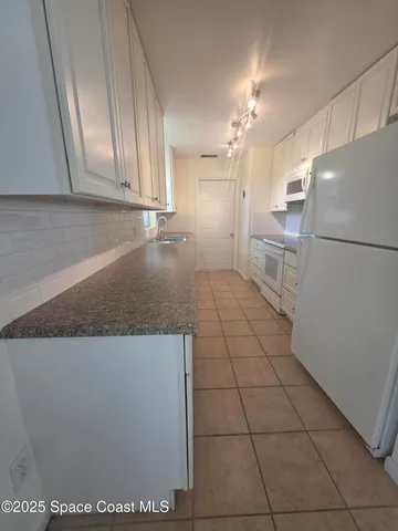 a kitchen with a refrigerator a stove a sink and dishwasher