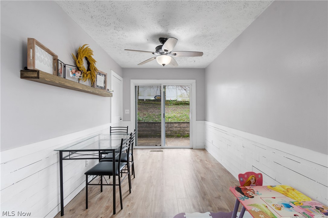 1934 Springfield Center Road Akron, OH 44312 - Photo 13 of 30 Dining space with ceiling fan, light hardwood / wood-style flooring, and a textured ceiling