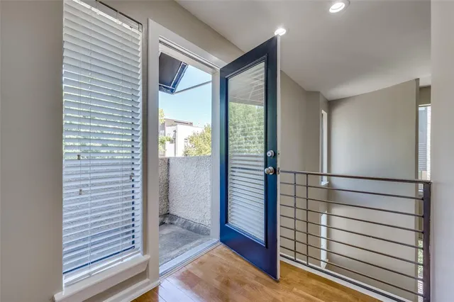 a view of hallway with wooden floor