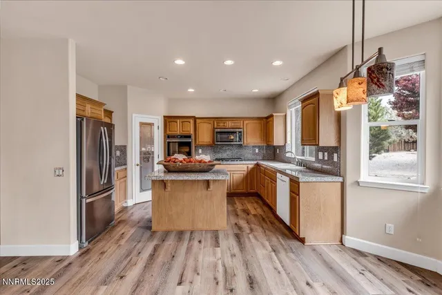a kitchen with sink refrigerator and stove