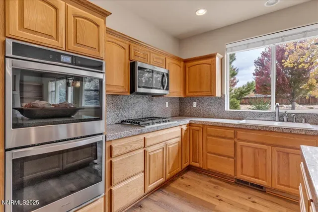 an empty room with chandelier fan and windows