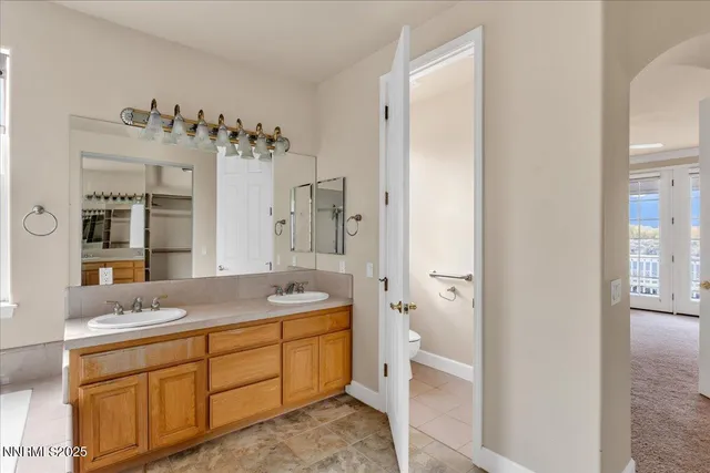 a view of an house with a big yard plants and large trees