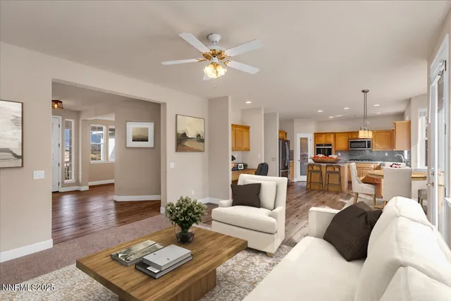 a kitchen with stainless steel appliances granite countertop a refrigerator a sink dishwasher a stove and white countertops with wooden floor