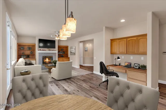 an empty room with wooden floor and chandelier