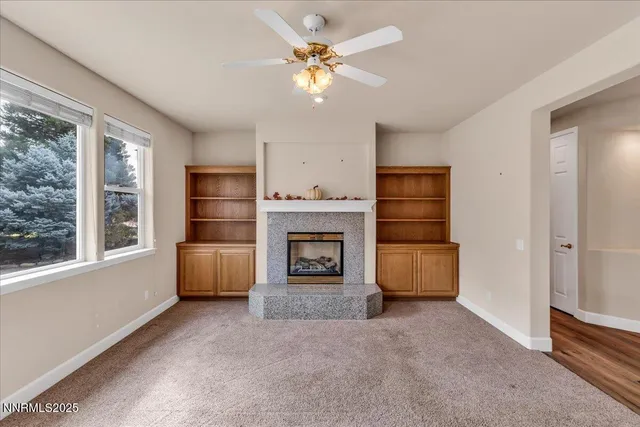 a kitchen with stainless steel appliances granite countertop a refrigerator a sink dishwasher a stove and a dining table with wooden floor