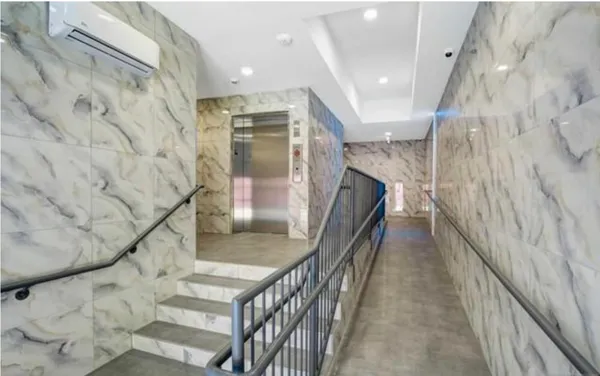 a view of a hallway with wooden floor and staircase