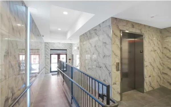 a view of a garage with white cabinets