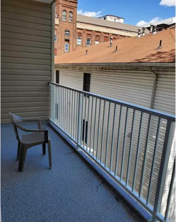 a view of a kitchen with wooden floor and a sink