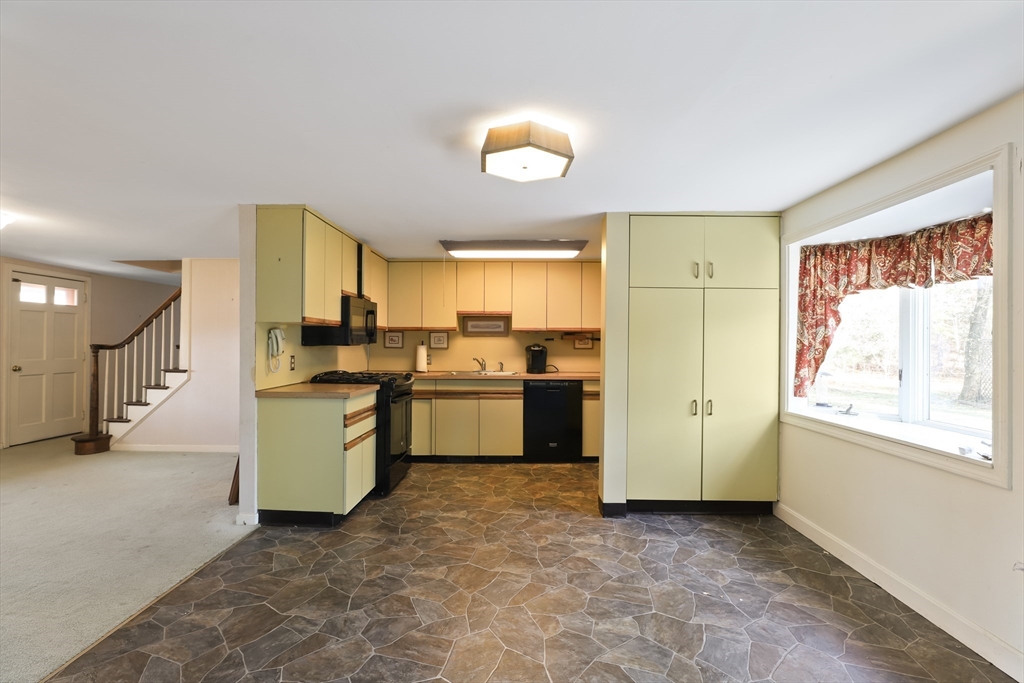 22 Coolidge Road Walpole, MA 02081 - Photo 11 of 25 a view of a kitchen with wooden floor and a window