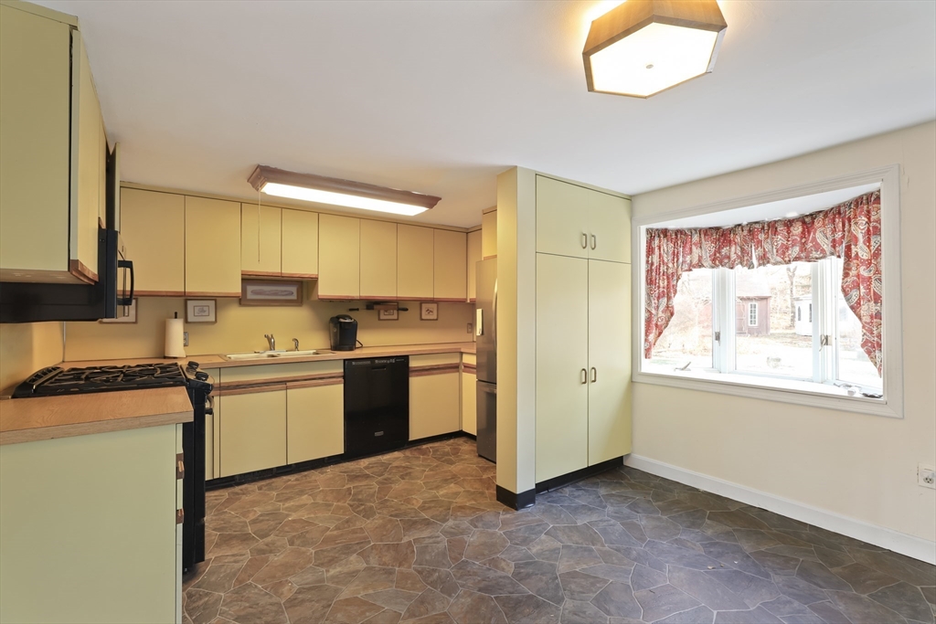 22 Coolidge Road Walpole, MA 02081 - Photo 12 of 25 a kitchen with a refrigerator and a stove top oven
