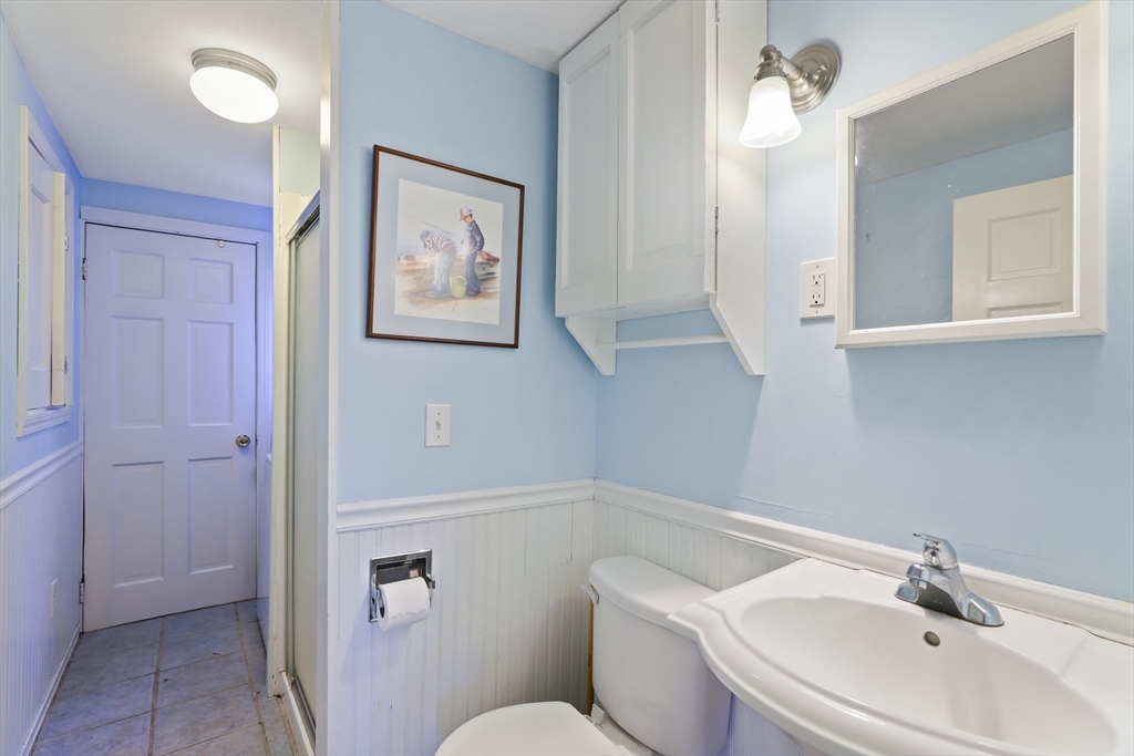 22 Coolidge Road Walpole, MA 02081 - Photo 8 of 25 a bathroom with a toilet sink and mirror