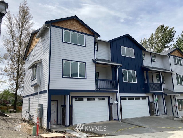 319 South 48th Court, Unit 13 Renton, WA 98055 - Photo 1 of 33 a front view of a house with a garage