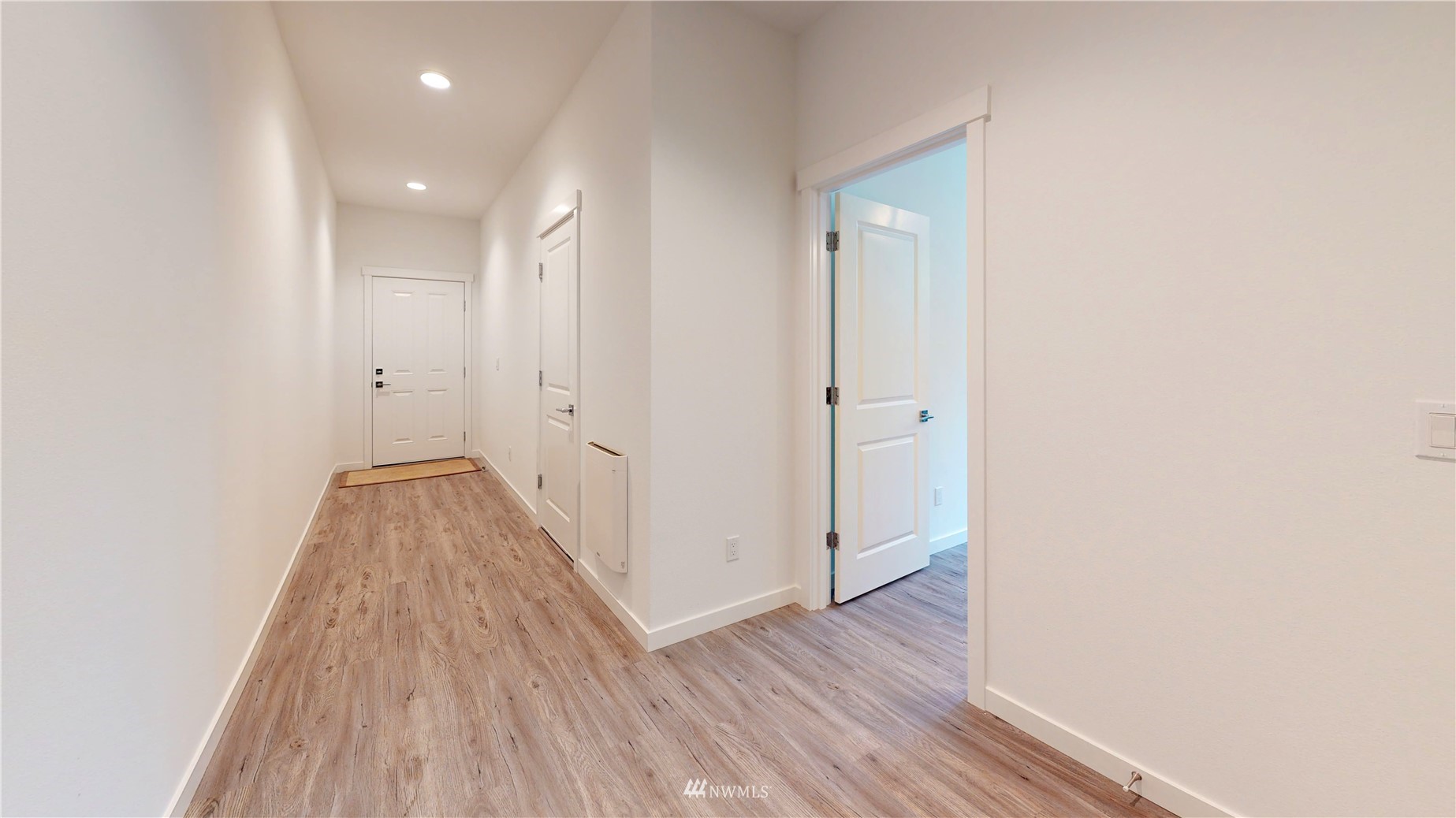 319 South 48th Court, Unit 13 Renton, WA 98055 - Photo 26 of 33 a view of a hallway with wooden floor and a bathroom