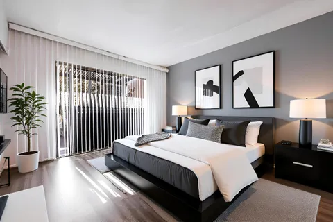 a bedroom with a bed and a potted plant