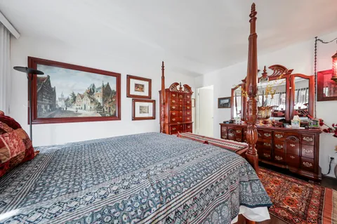 a view of a bedroom with furniture and window