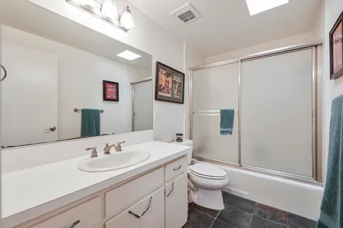 a bathroom with a toilet sink shower and mirror