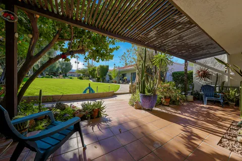 a view of a chairs and table in backyard