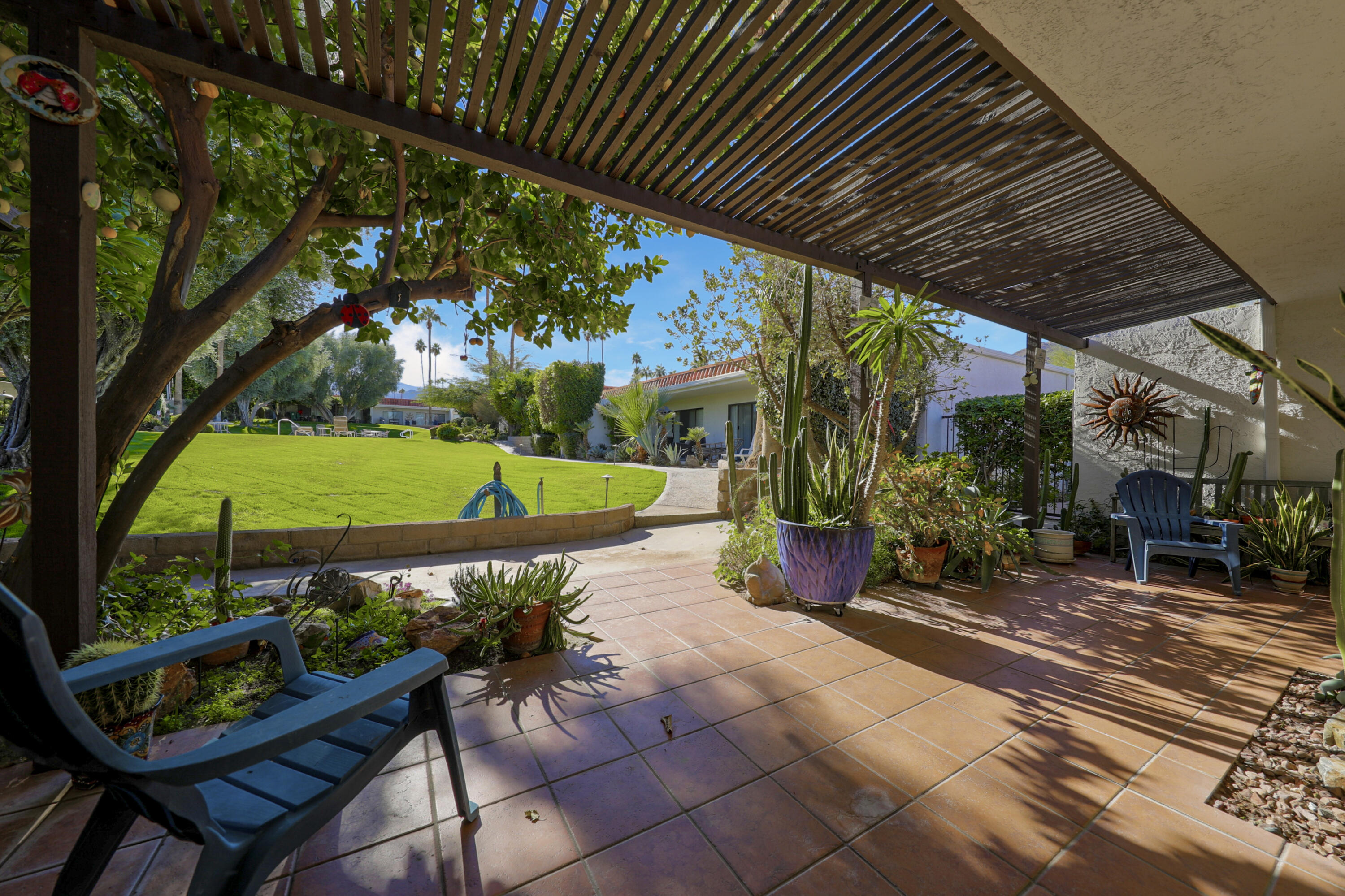 45760 Ocotillo Drive Palm Desert, CA 92260 - Photo 19 of 29 a view of a chairs and table in backyard