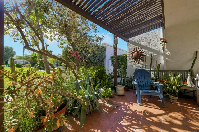 a view of a patio with table and chairs and potted plants