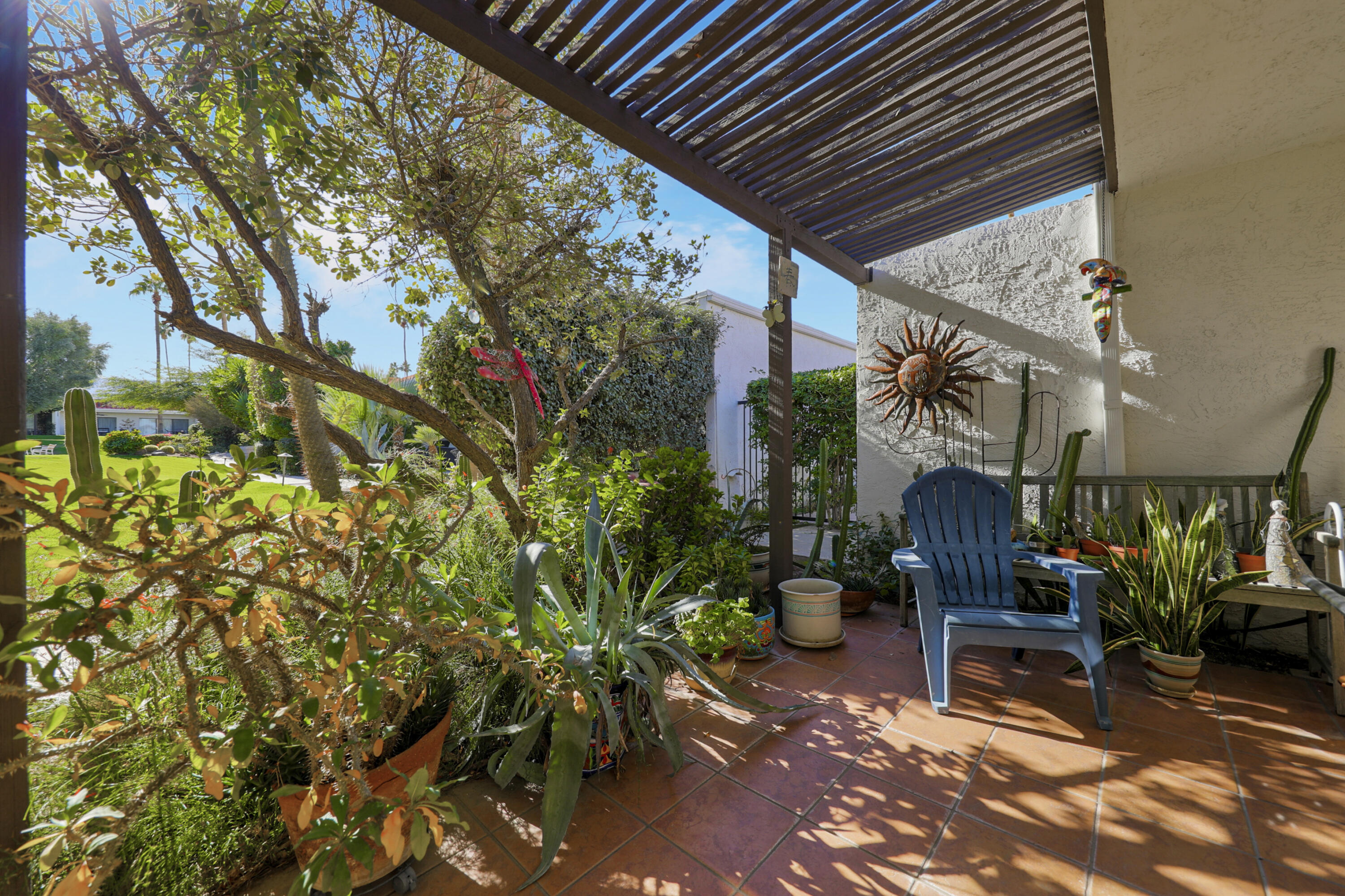 45760 Ocotillo Drive Palm Desert, CA 92260 - Photo 20 of 29 a view of a patio with table and chairs and potted plants