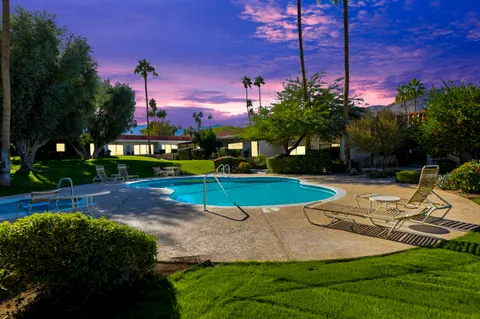 a view of a park with large trees