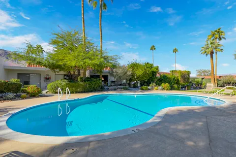 a view of a swimming pool with a yard