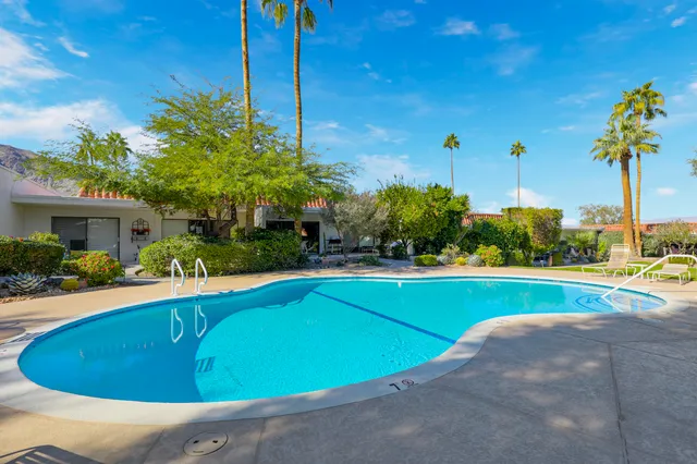 a view of a swimming pool with a yard