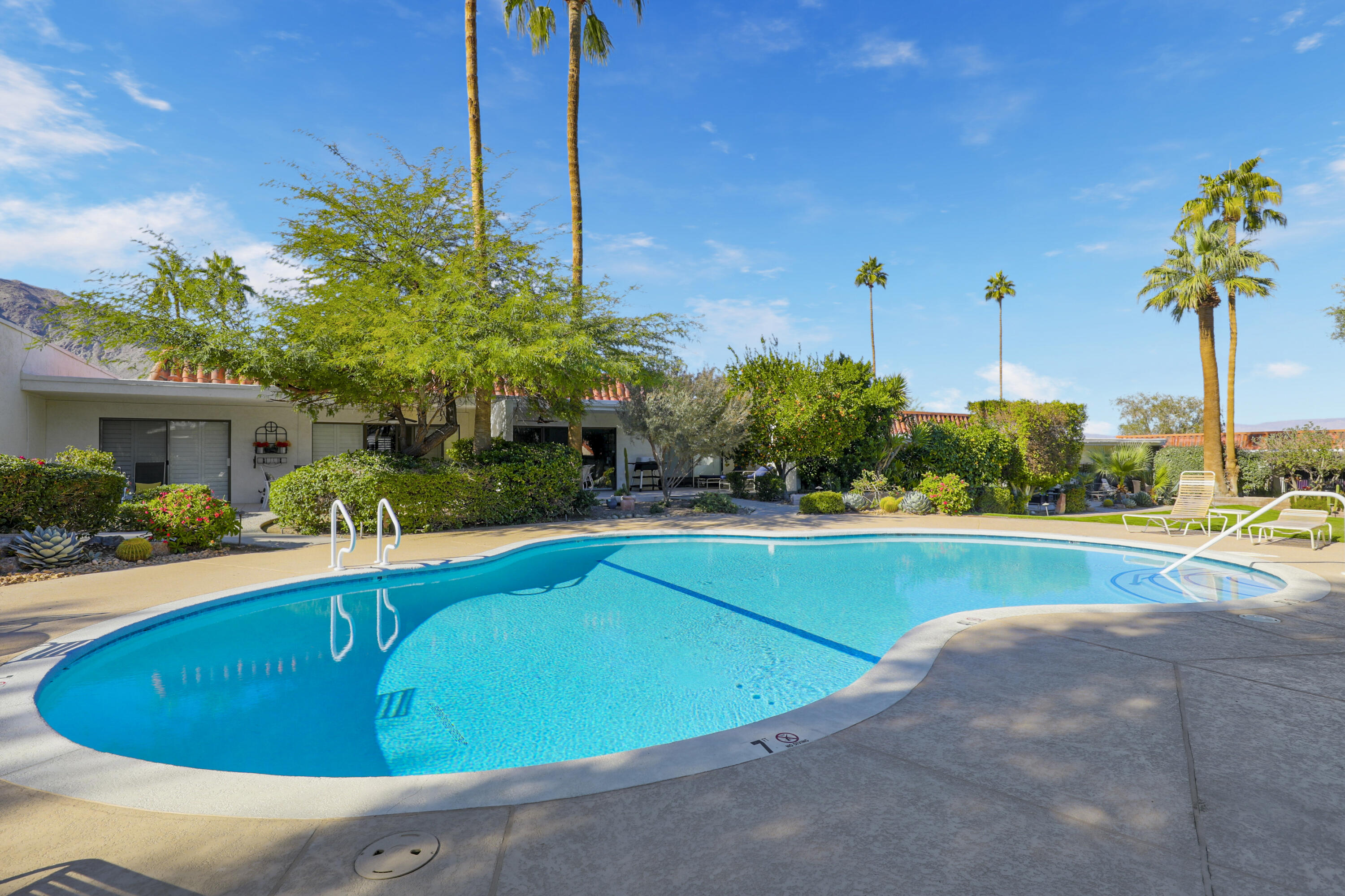 45760 Ocotillo Drive Palm Desert, CA 92260 - Photo 28 of 29 a view of a swimming pool with a yard