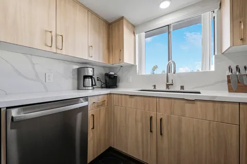 a kitchen with stainless steel appliances white cabinets and a sink