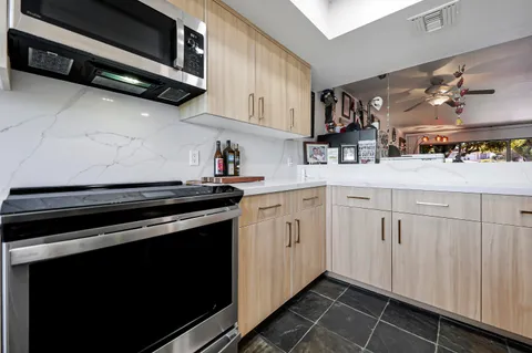a kitchen with stainless steel appliances a stove a microwave and cabinets